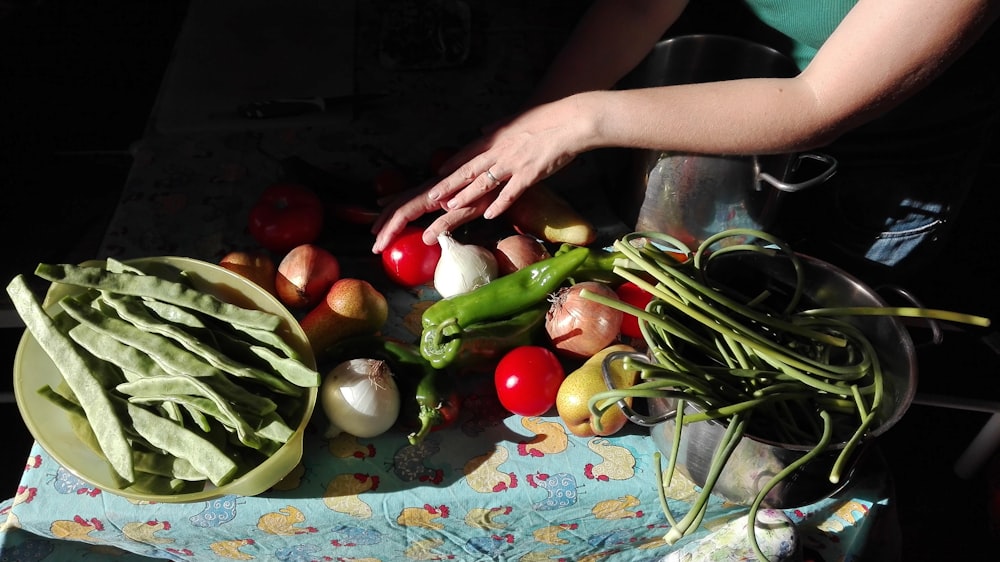 a person cutting up vegetables on a table