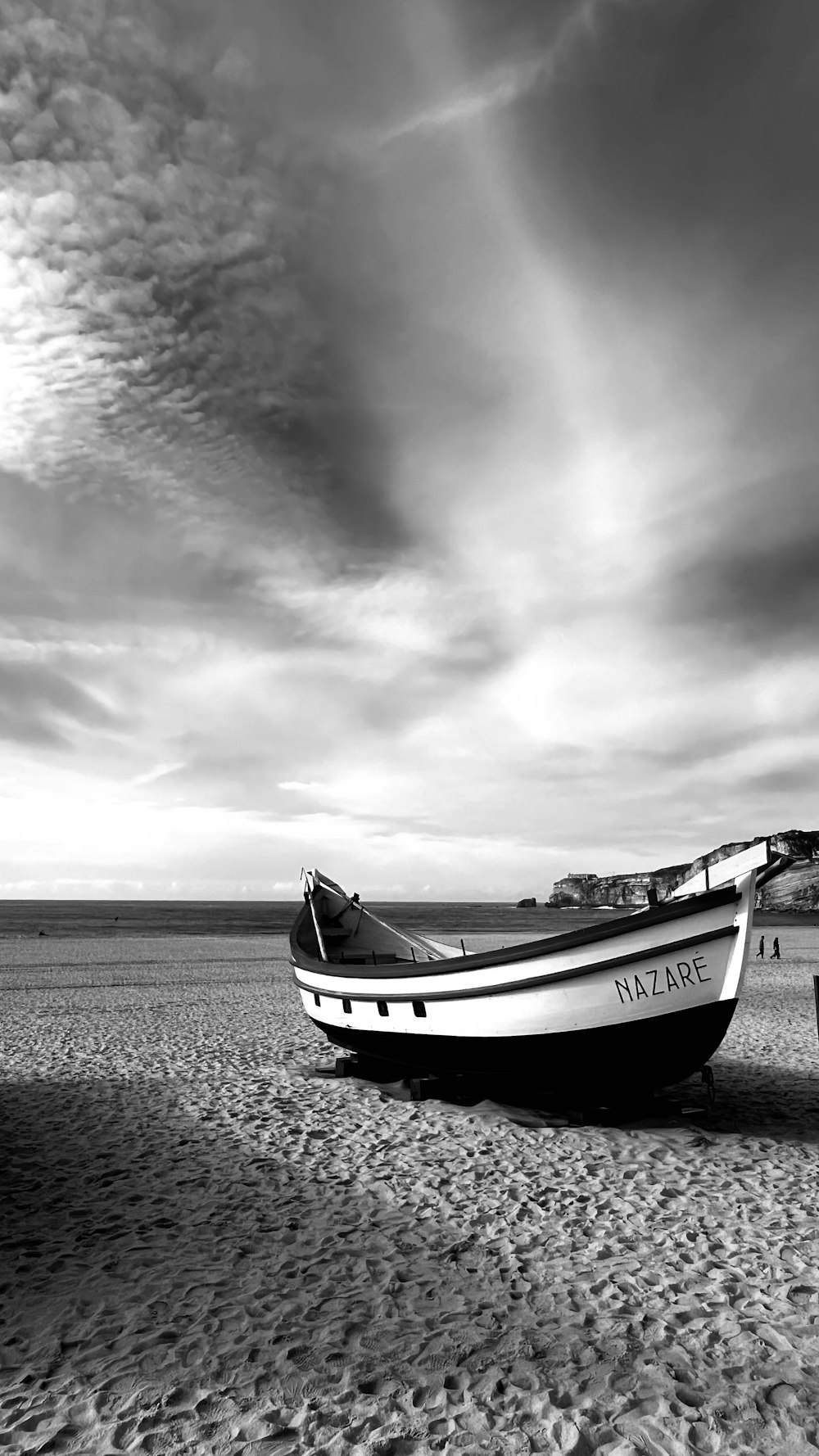 a boat sitting on top of a sandy beach