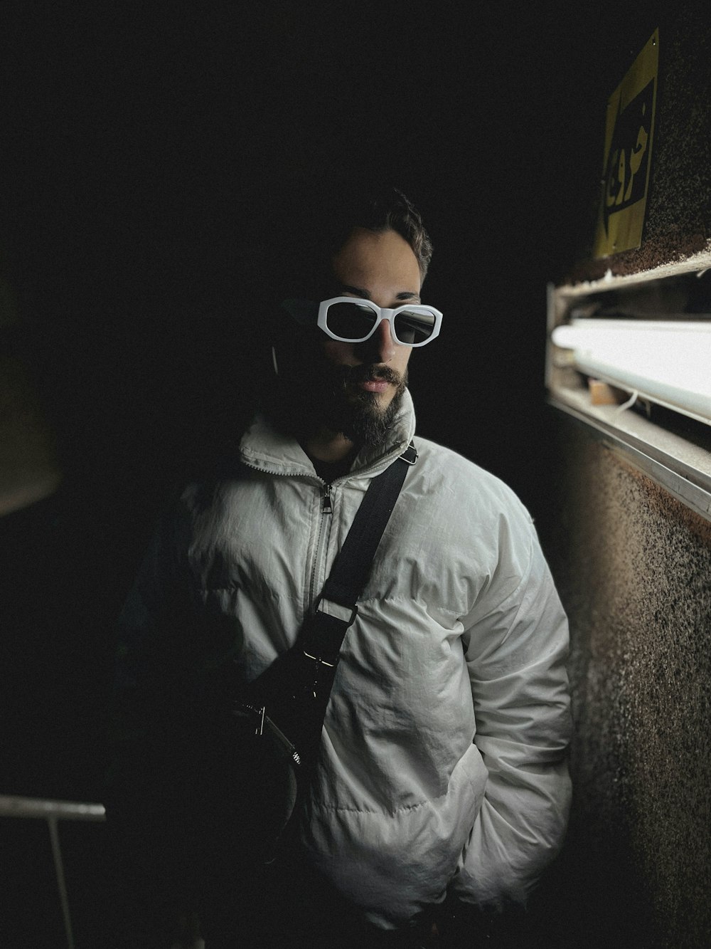 a man wearing white sunglasses and a white jacket