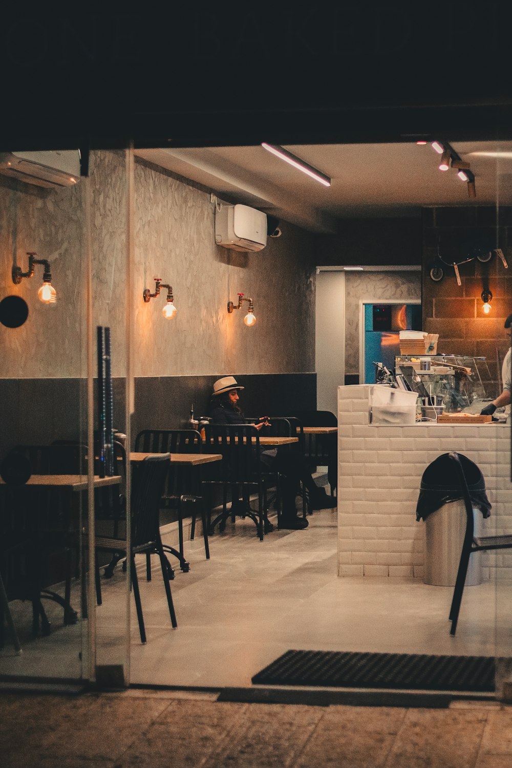 a restaurant with tables, chairs, and a counter