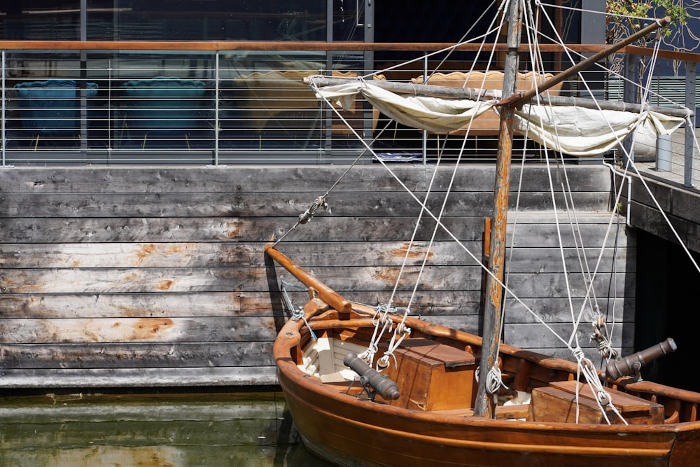 a wooden boat sitting in the water next to a building