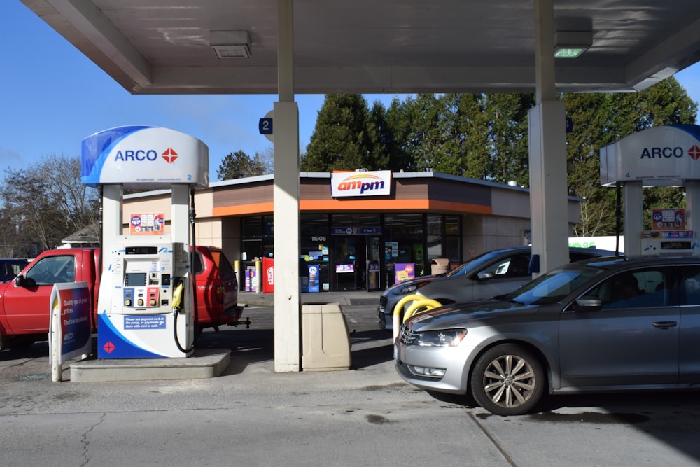 a gas station with cars parked in front of it