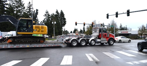a tractor trailer being towed down a street