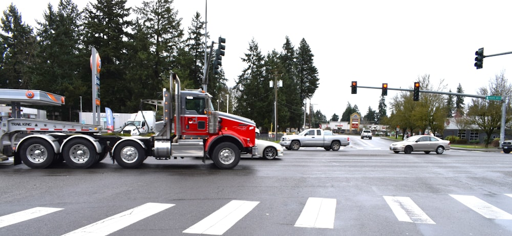 a large semi truck driving down a city street