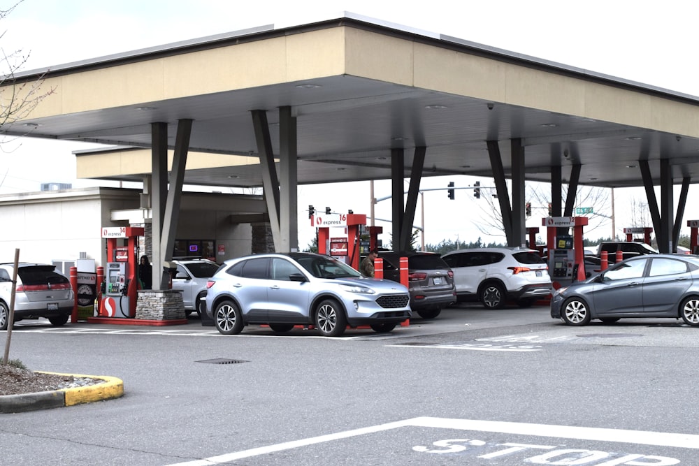 a gas station with several cars parked in the lot