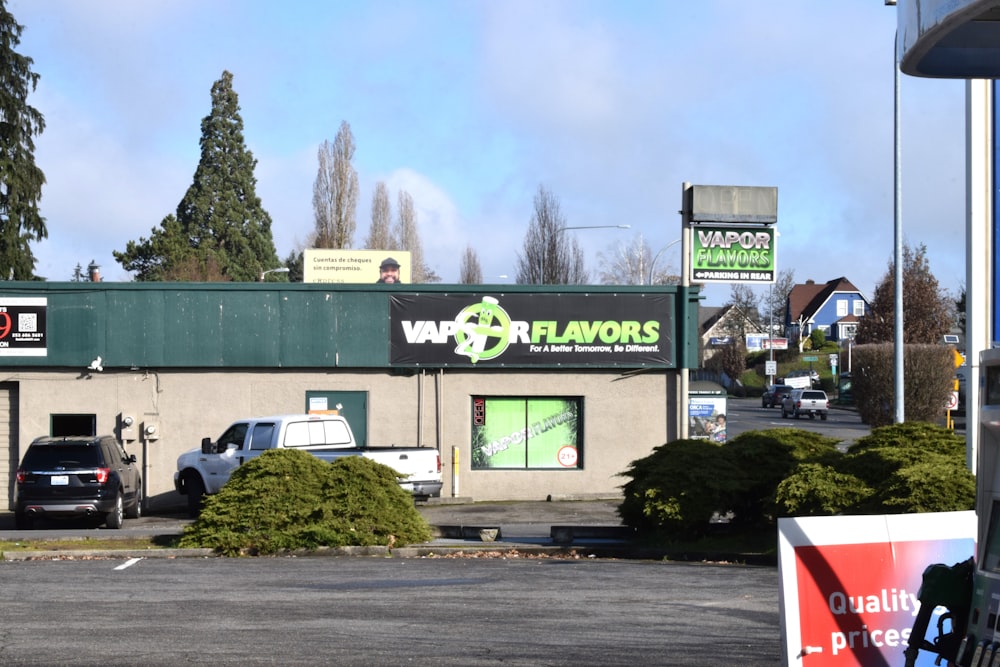 a store front with cars parked in front of it