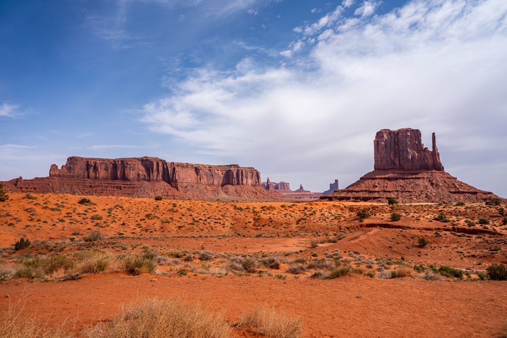 a desert landscape with mountains in the background