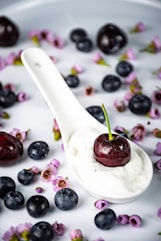 a spoon filled with yogurt and blueberries