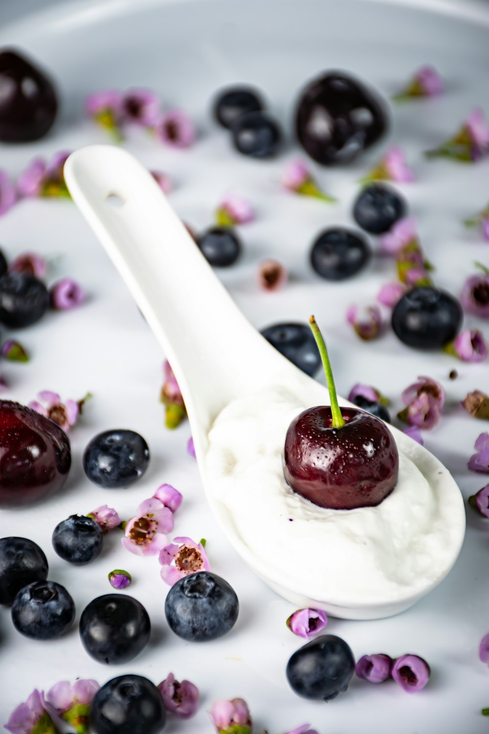 a spoon filled with yogurt and blueberries