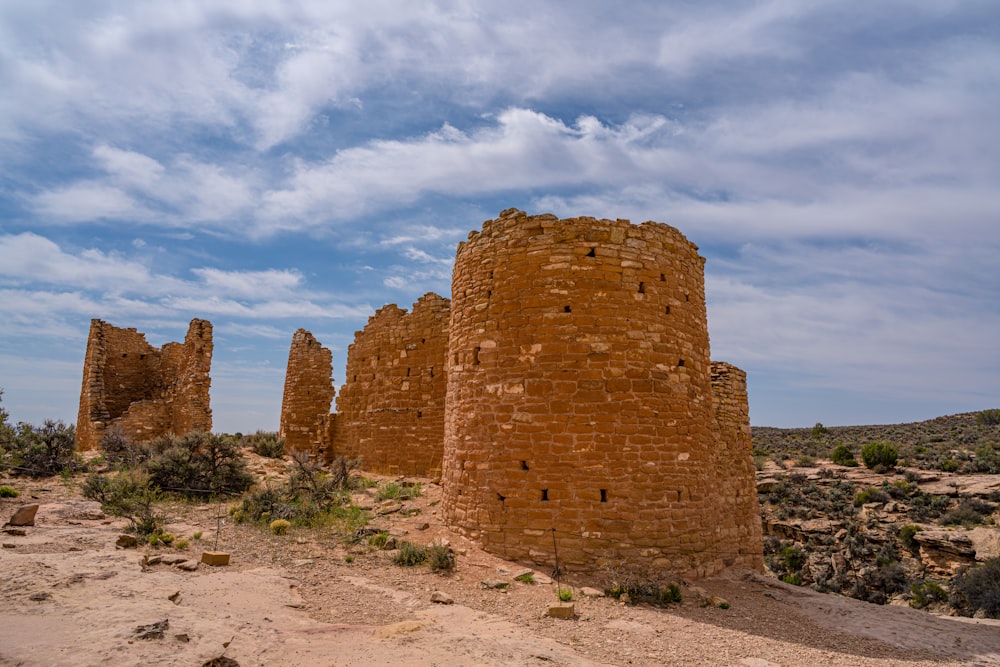 a group of brick structures sitting in the middle of a desert