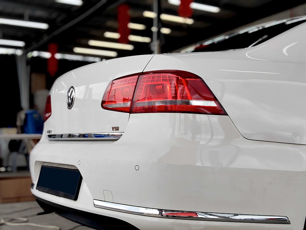 a white car is parked in a garage