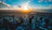 the sun is setting over a large city