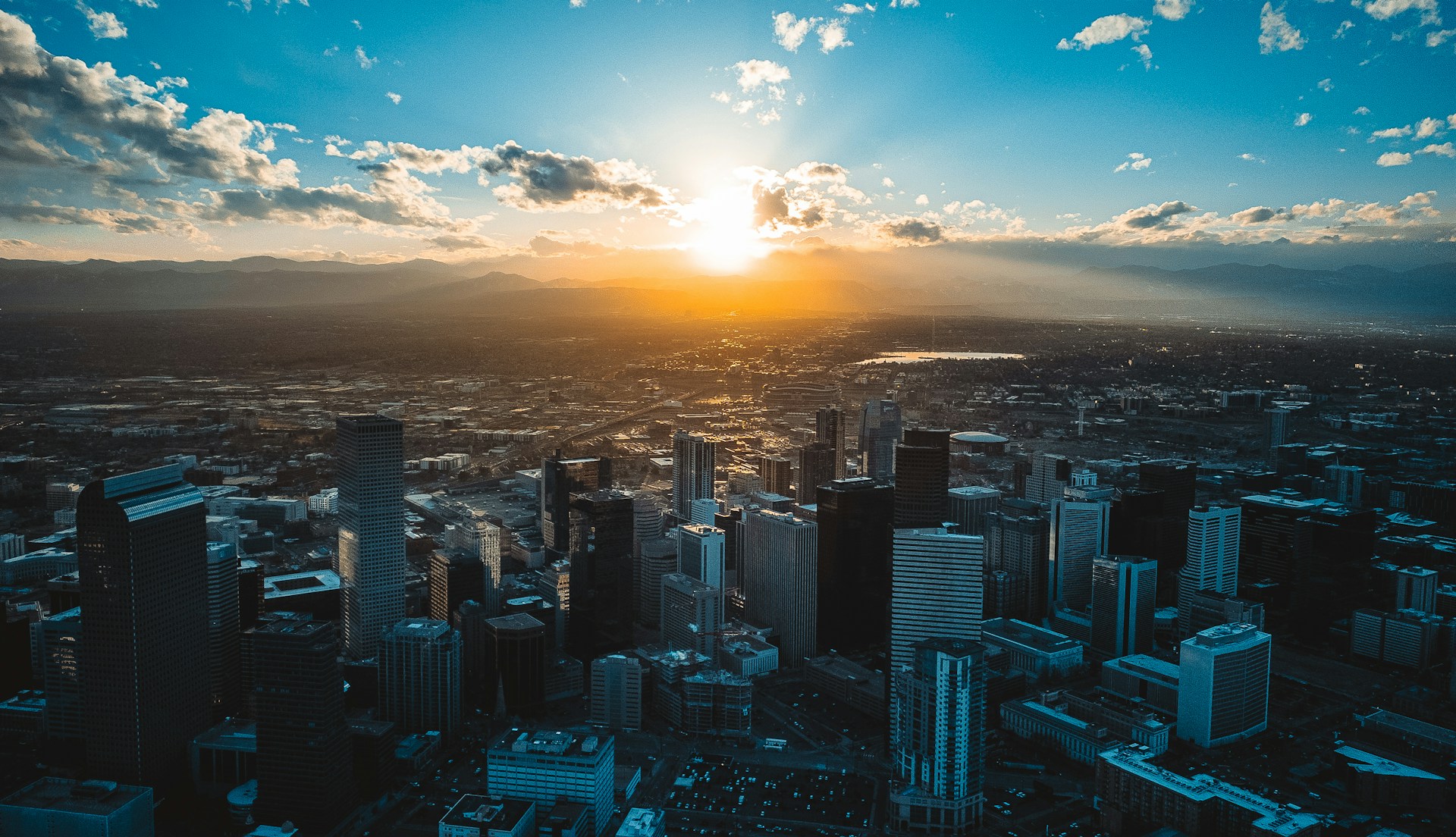 the sun is setting over a large city