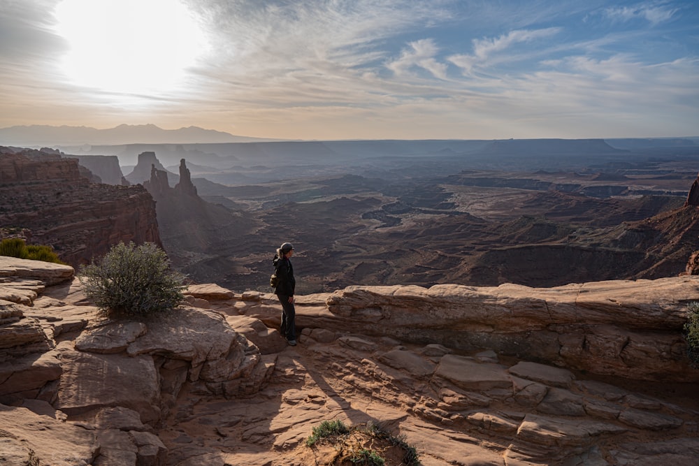 a person standing on top of a rocky cliff