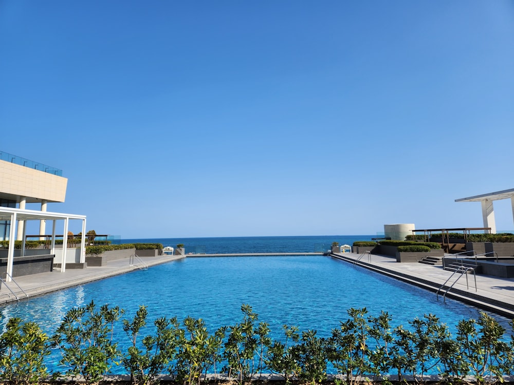 a large swimming pool with a view of the ocean