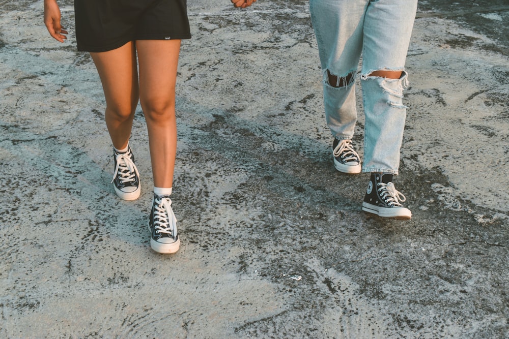 a man and a woman walking down a dirt road