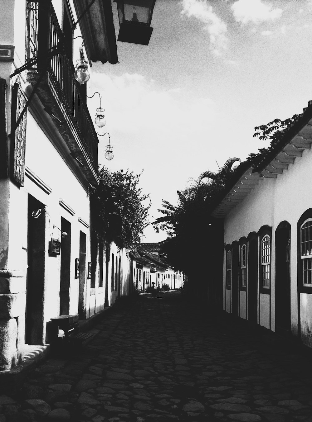 a black and white photo of a cobblestone street