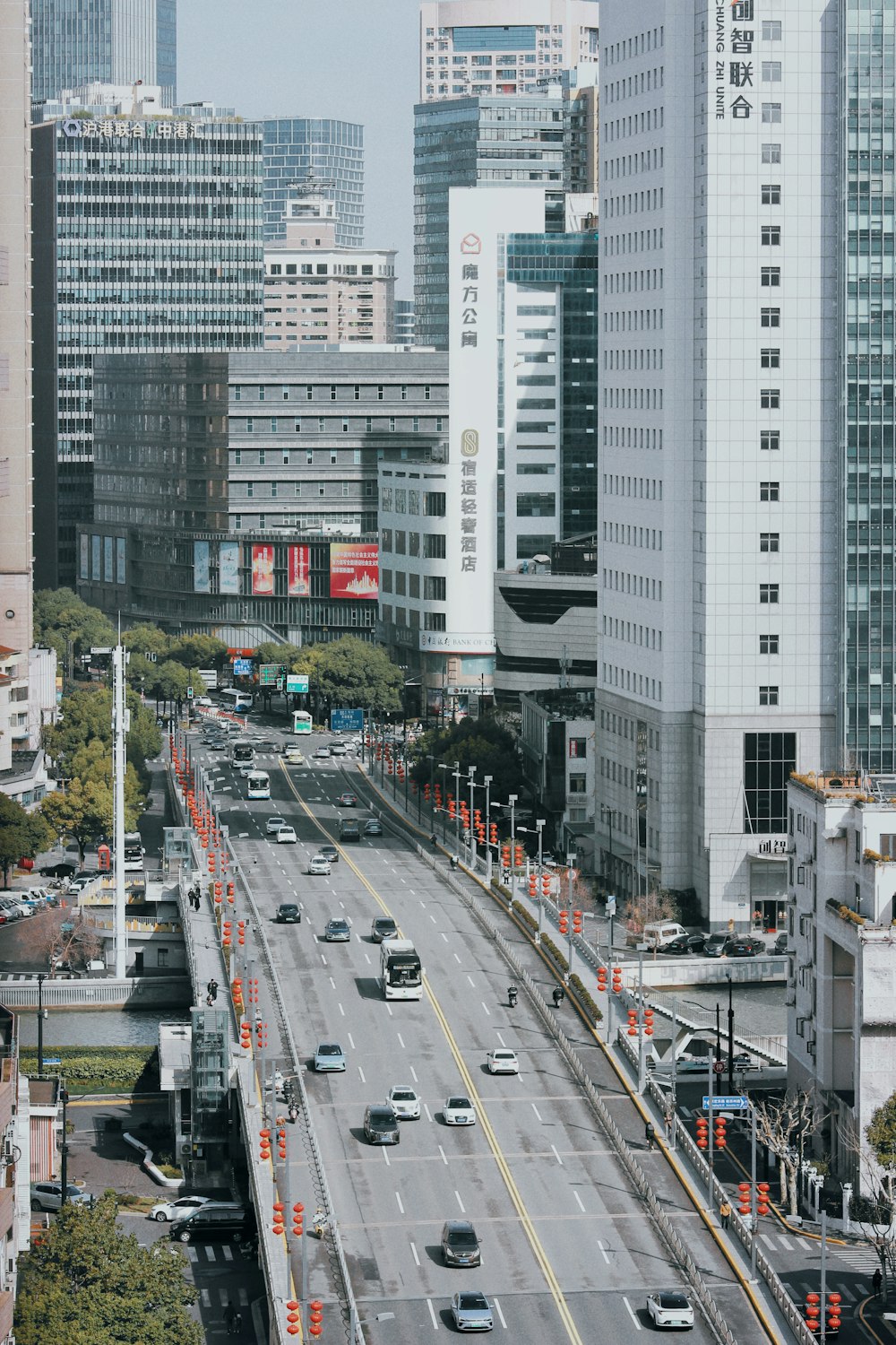 a city street filled with lots of traffic next to tall buildings