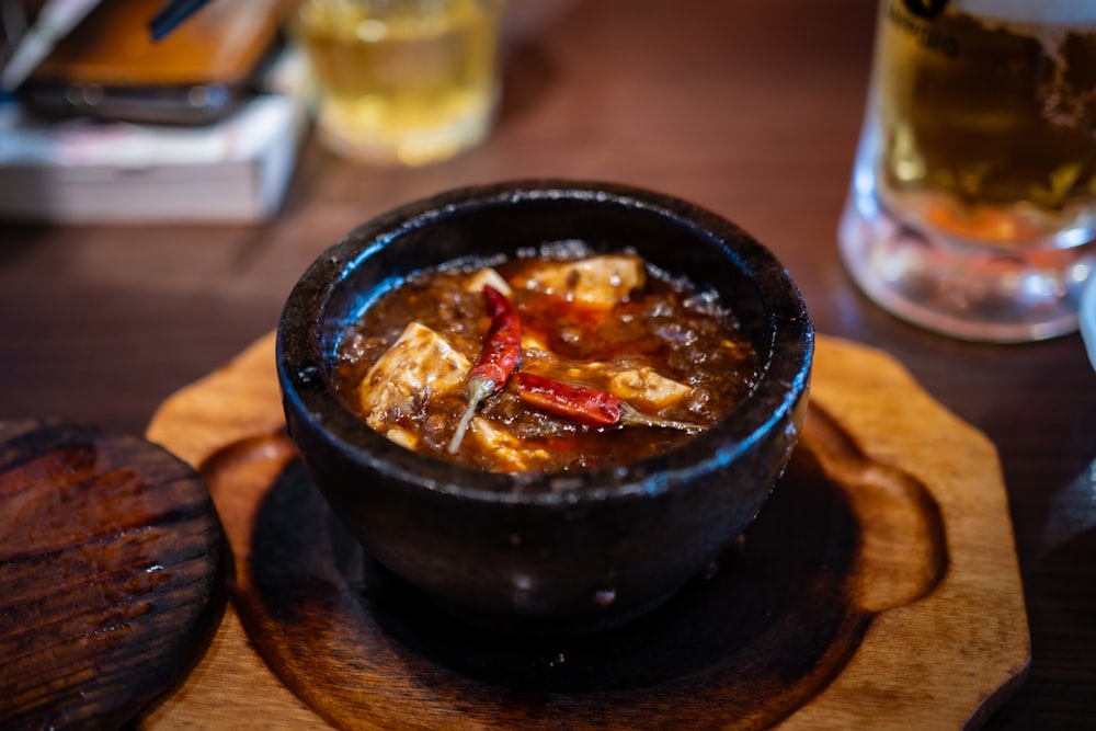 a bowl of food sitting on top of a wooden table