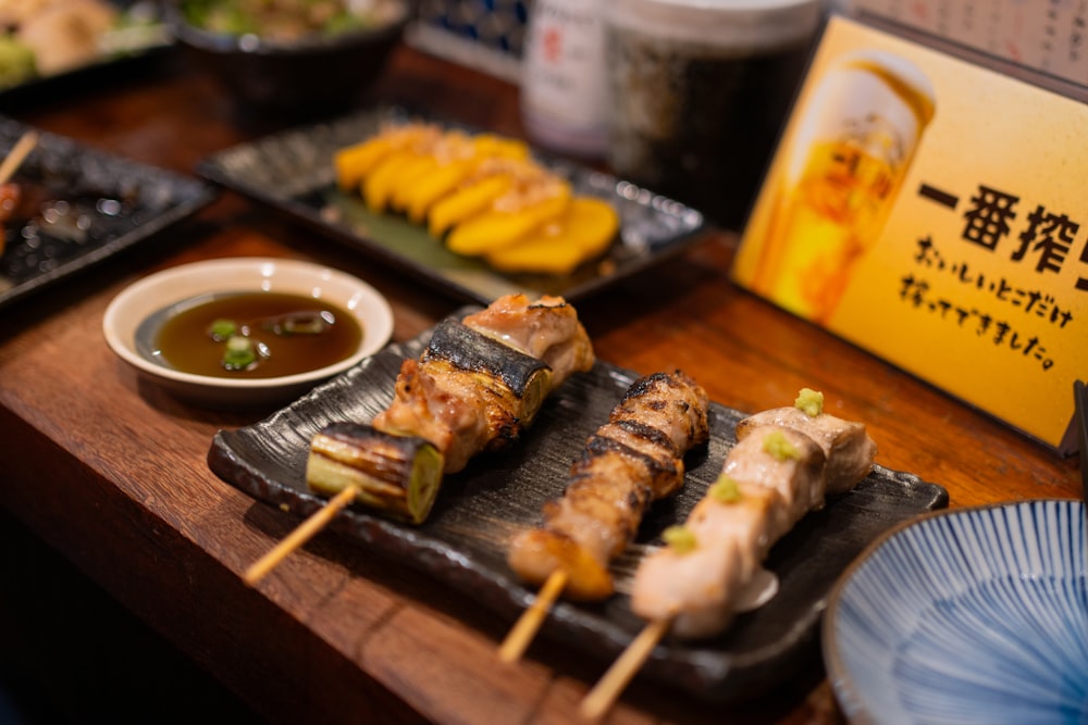 a wooden table topped with plates of food