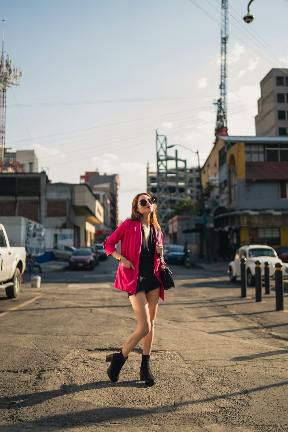 a woman in short shorts and a pink jacket