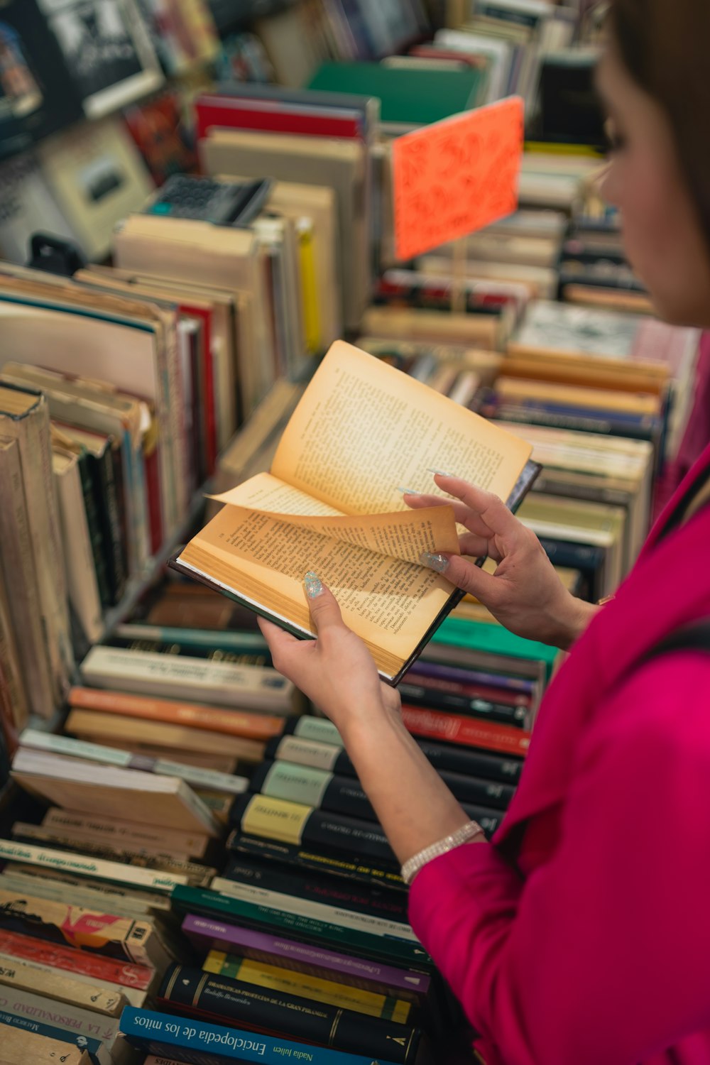 a woman reading a book in a library