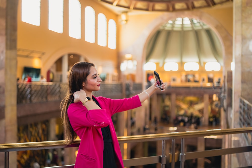 a woman taking a picture of herself with her cell phone