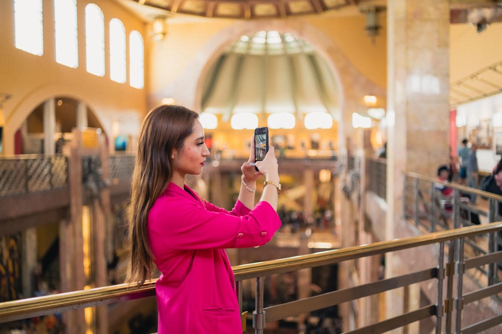 a woman taking a picture of herself in a mall