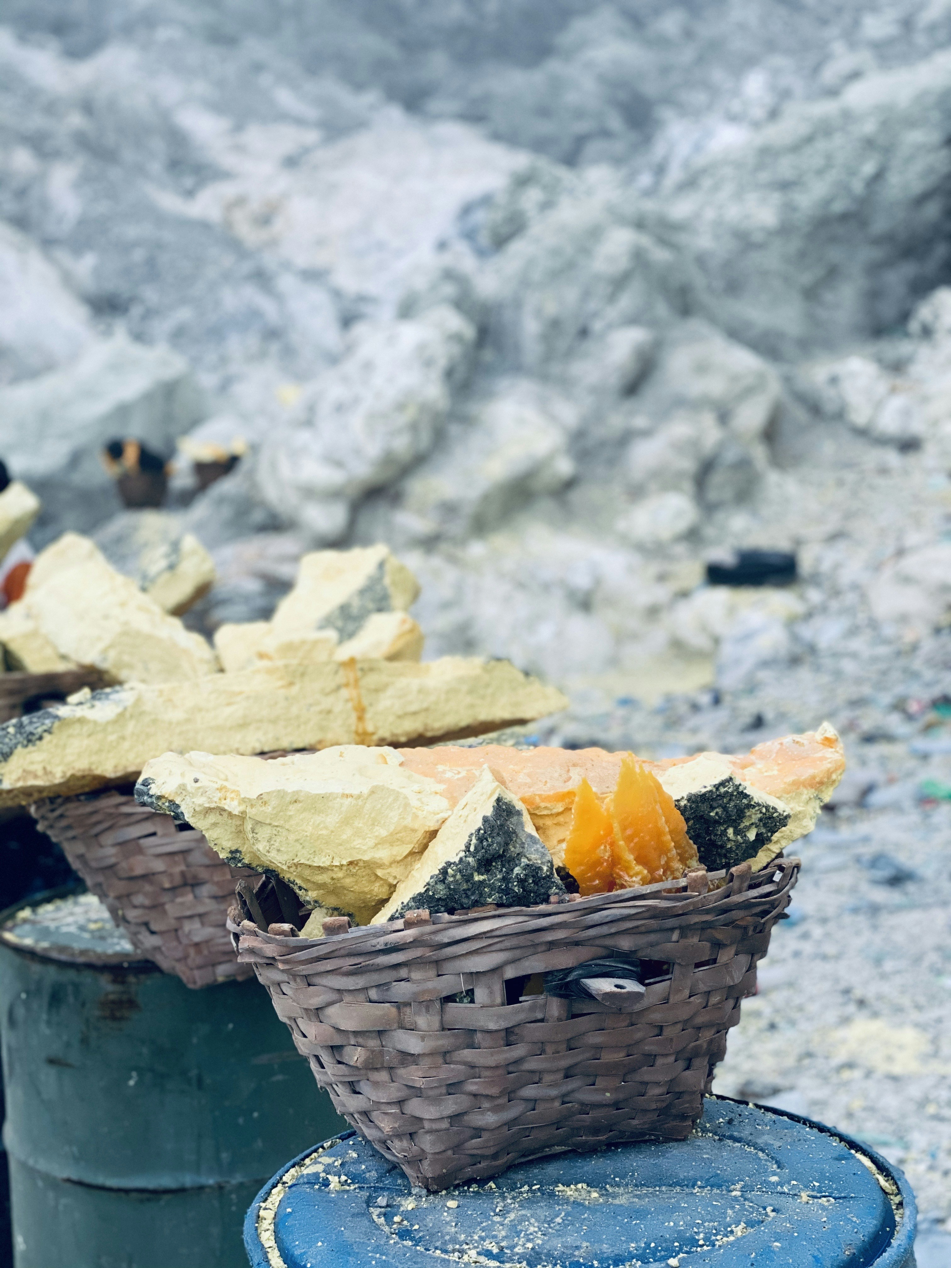 a basket of food sitting on top of a blue barrel