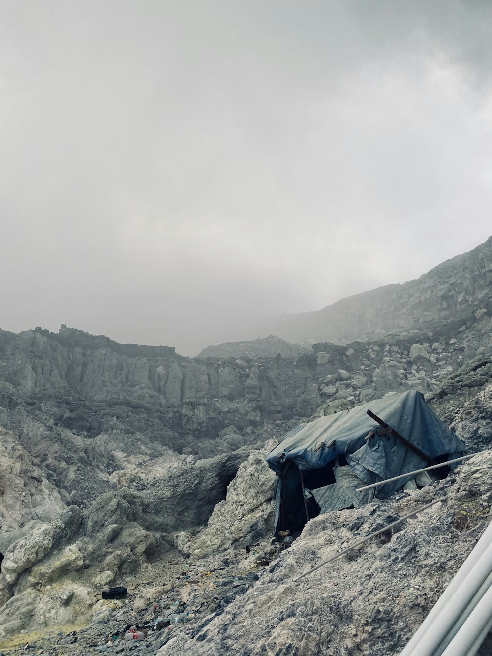 a tent pitched up on the side of a mountain