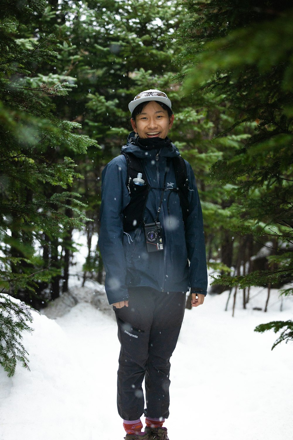 a man standing on a snowboard in the snow