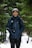 a person standing in the snow with a backpack