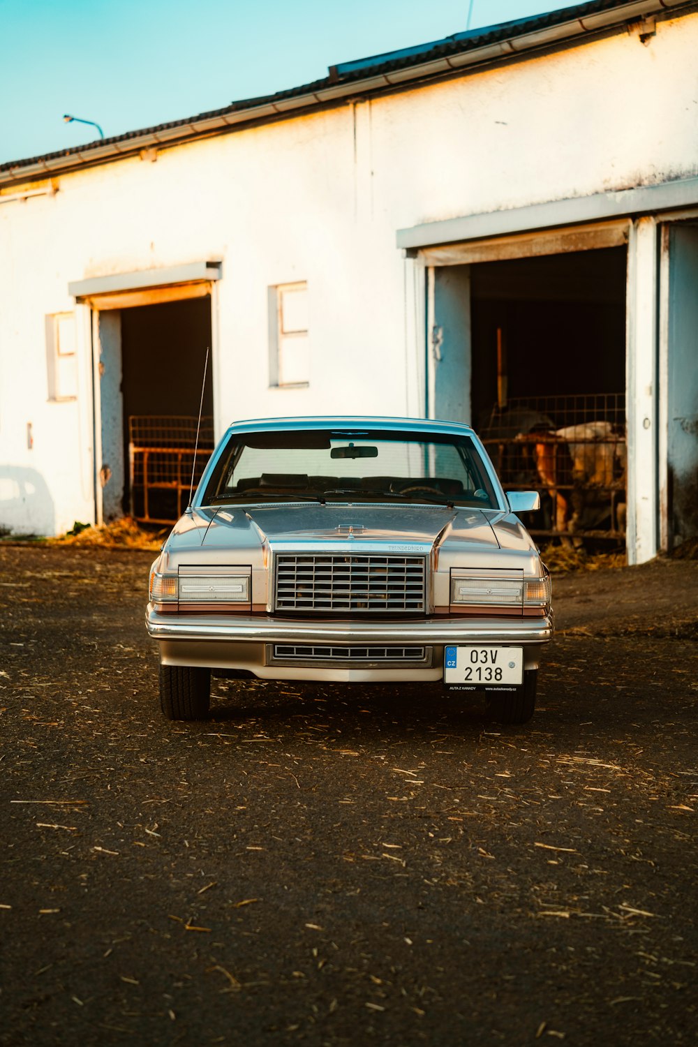 a car parked in front of a white building