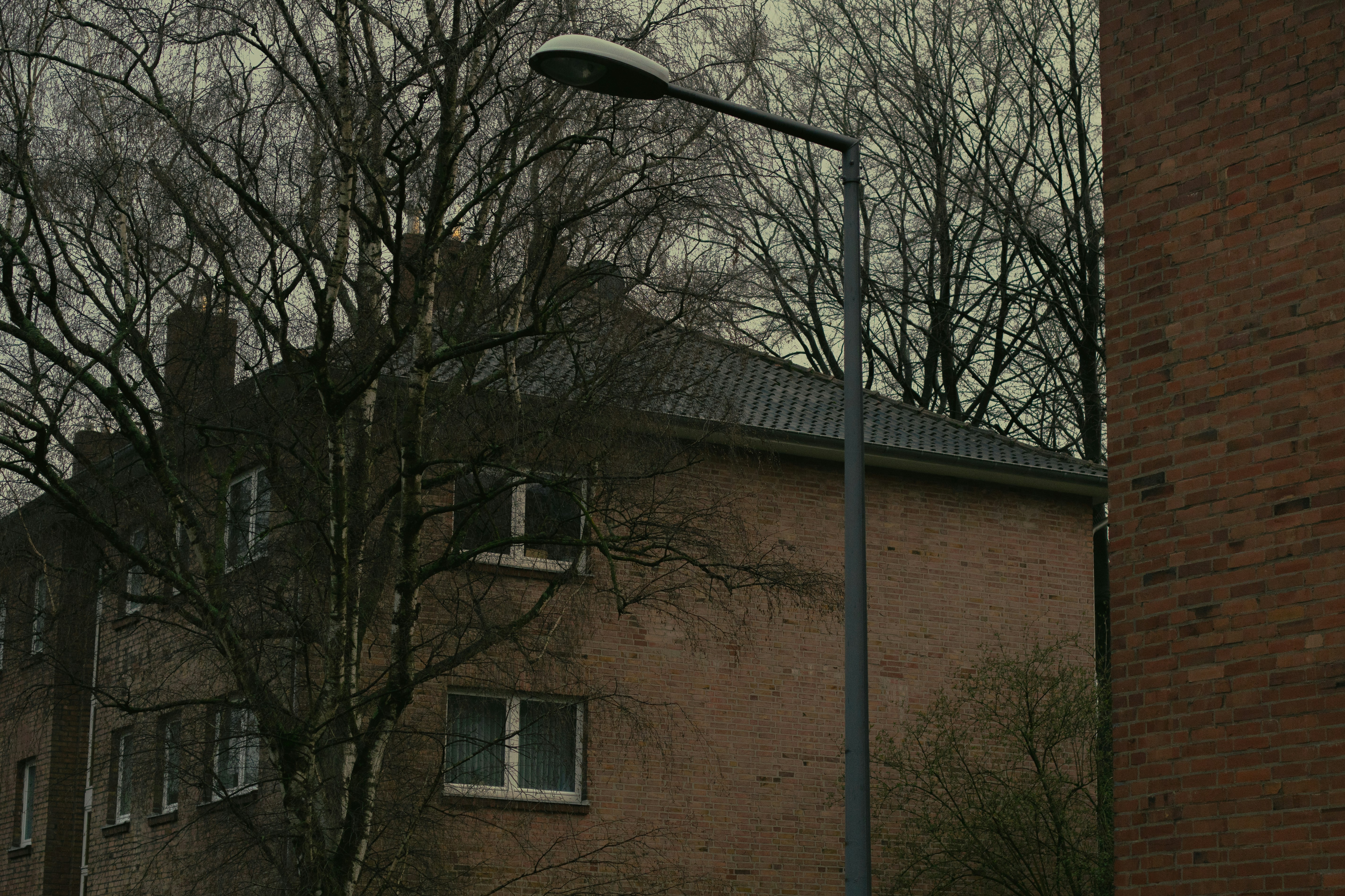 a street light next to a brick building
