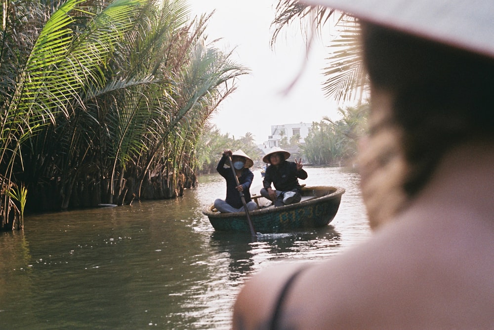 two people in a small boat on a river