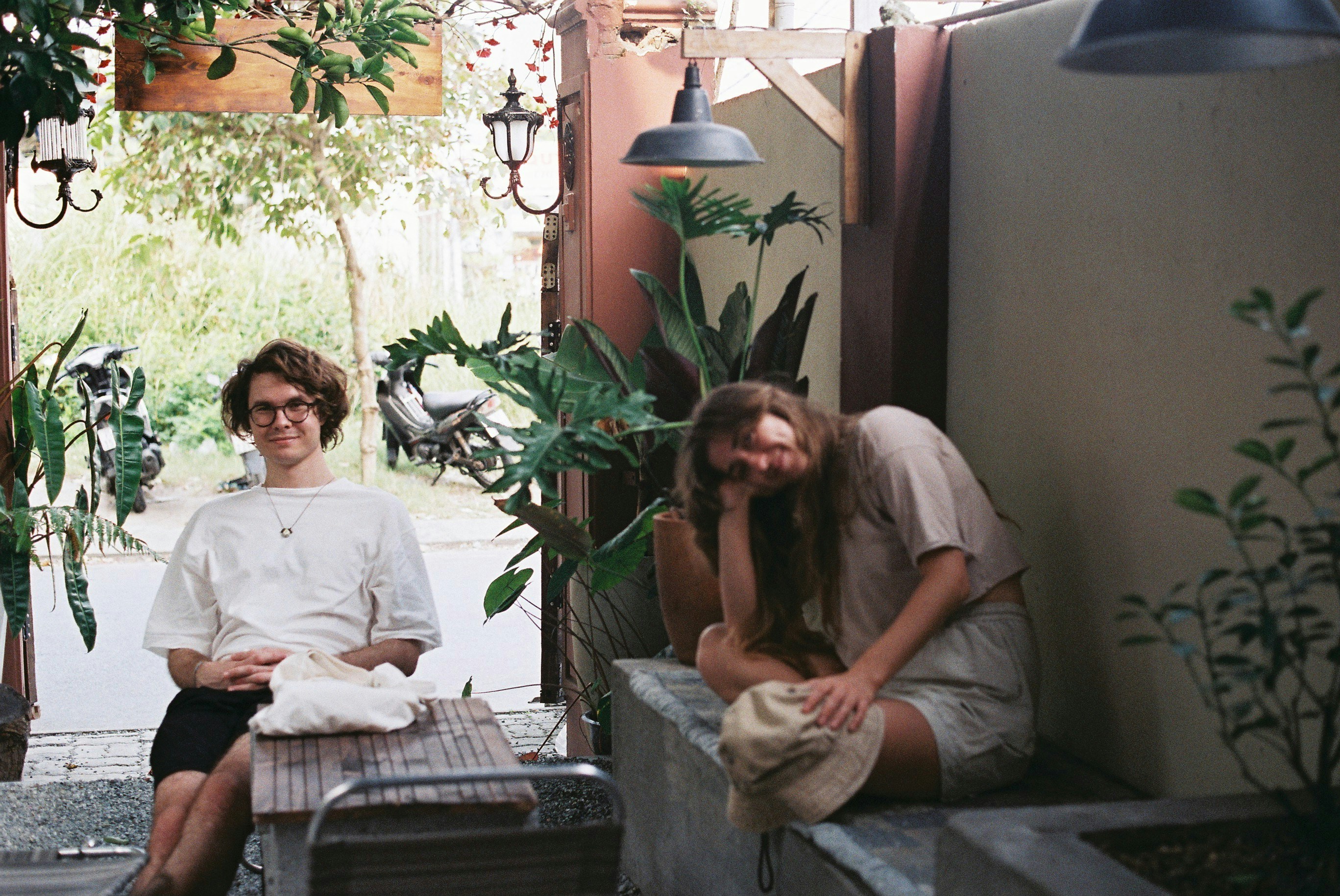 a man and a woman sitting on a bench