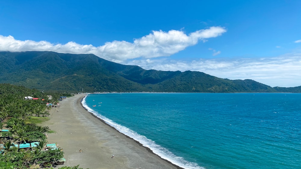 a view of a beach with mountains in the background