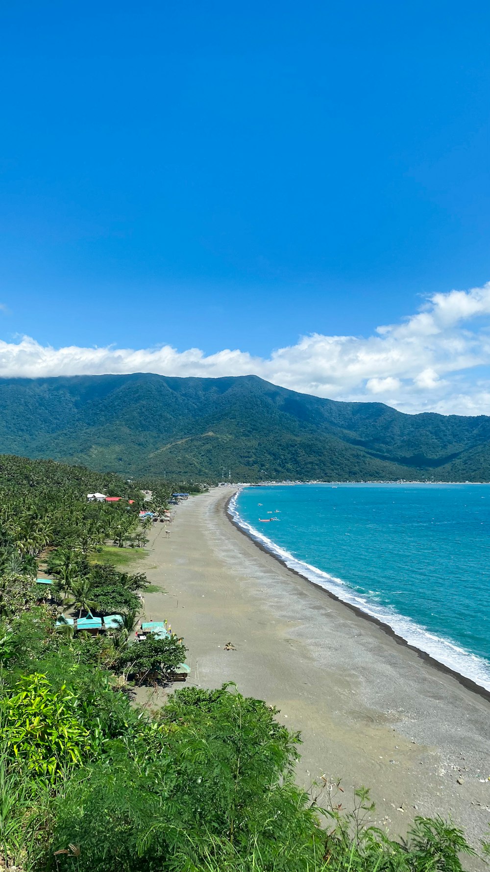 a view of a beach with a mountain in the background