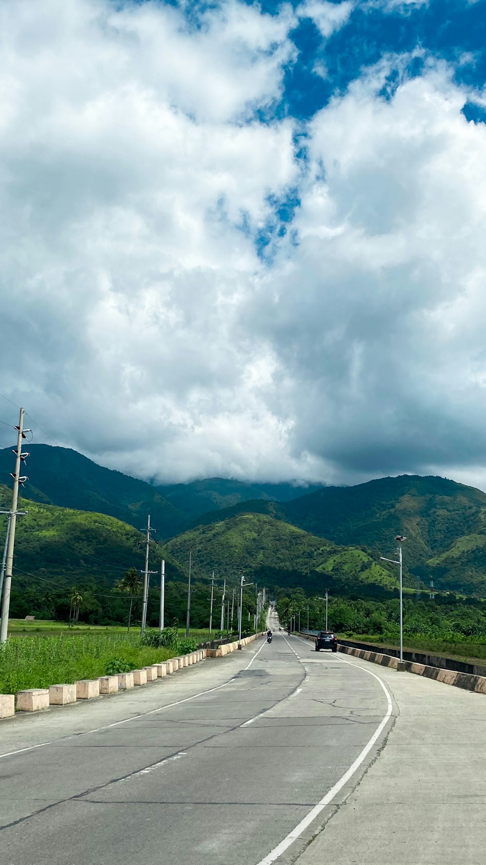 an empty road with mountains in the background