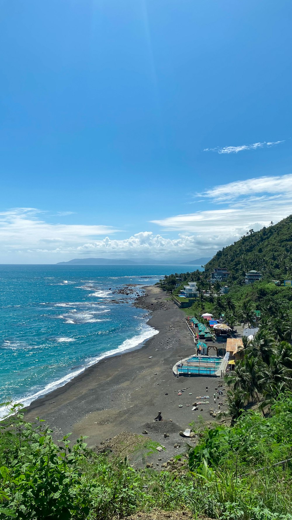 a view of a beach from a hill