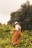 a woman in a field of yellow flowers