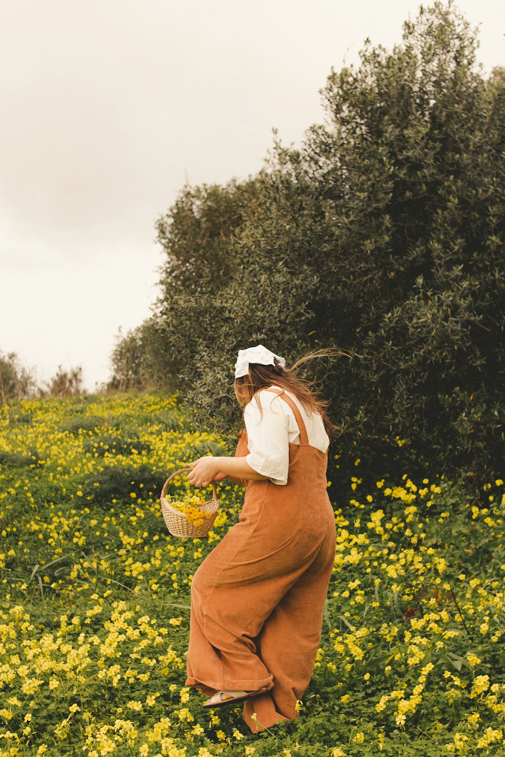 a woman in a field of yellow flowers