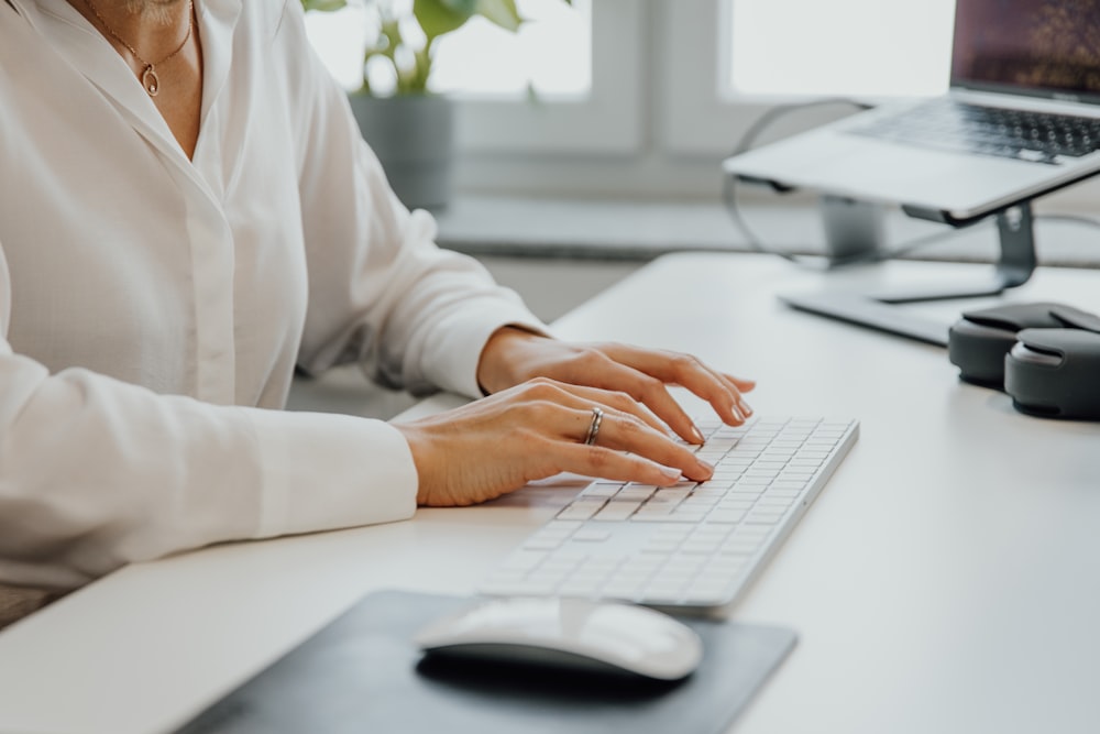 a woman is typing on a computer keyboard