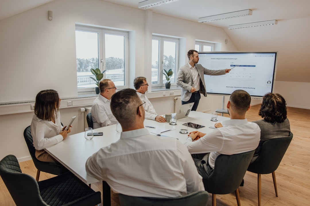 A diverse group of business professionals discussing personalized campaign effectiveness in a modern meeting room.