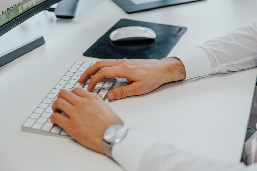 a man is typing on a computer keyboard