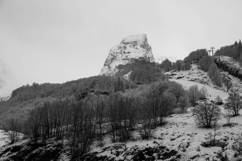 a black and white photo of a snowy mountain