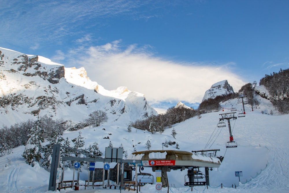 a ski lift on the side of a snowy mountain