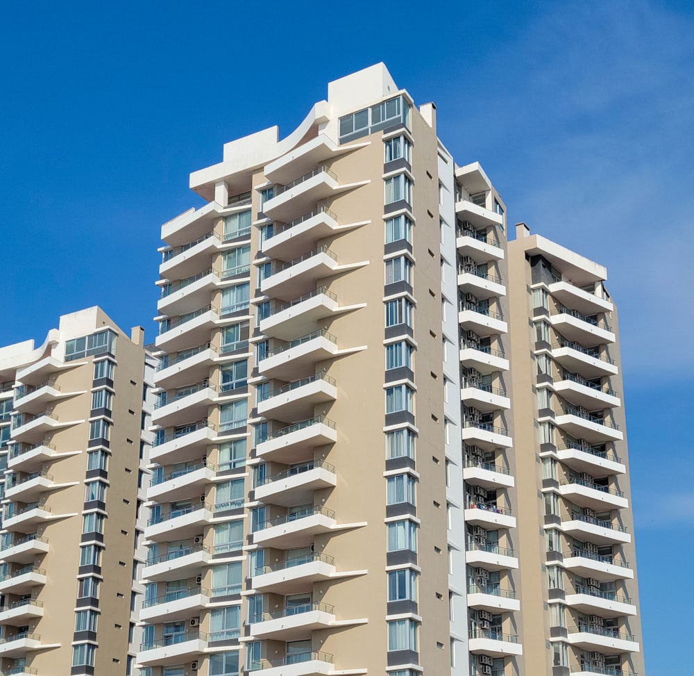 a tall building with balconies on the top of it