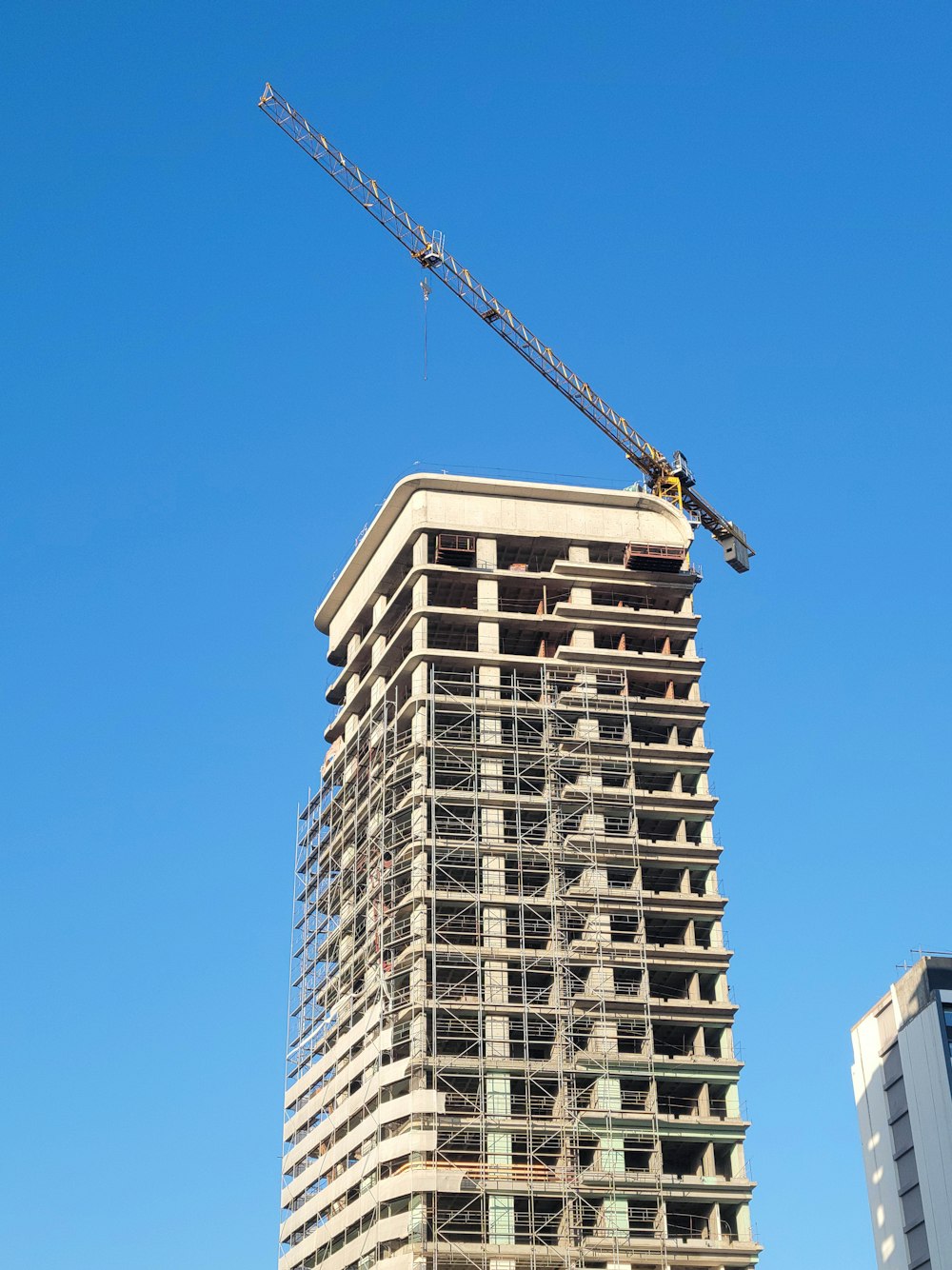 a tall building with a crane on top of it