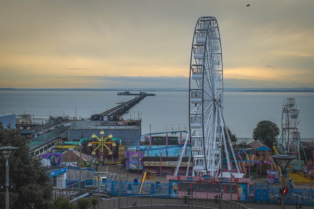 Un parque de atracciones con una noria en primer plano